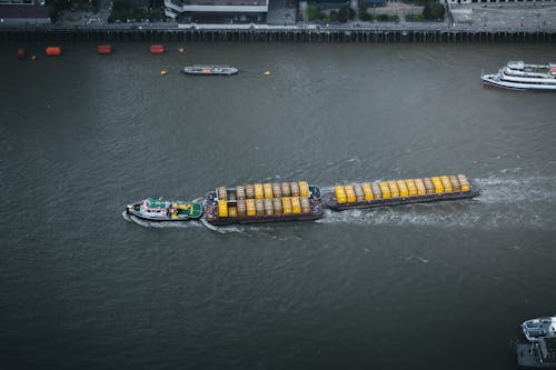 A boat traveling down the river with a large container