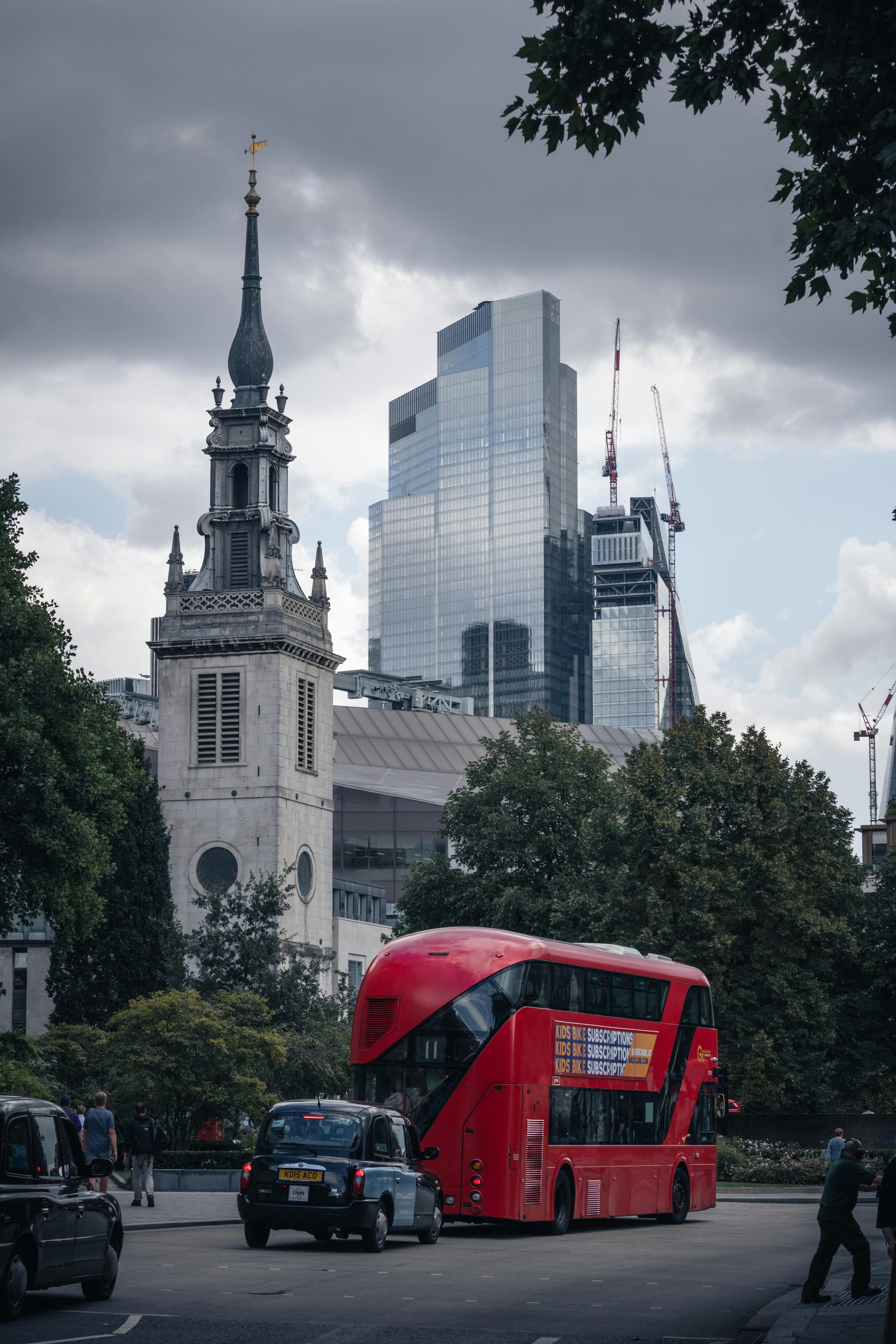 a red double decker bus driving down a street