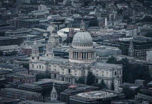 A stunning aerial photograph showcasing the iconic St. Paul's Cathedral amidst the bustling cityscape of London.