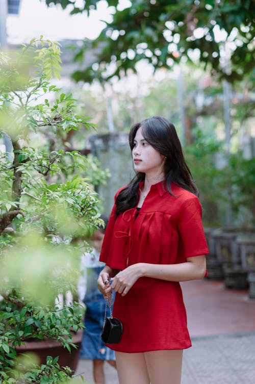 Pretty Woman in Red Dress Posing in Park