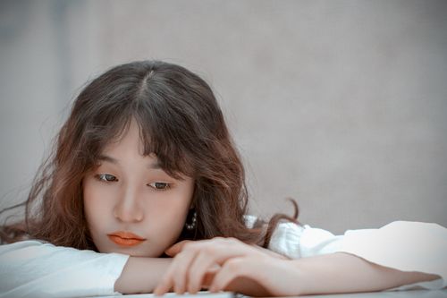Free Soft focus portrait of a young woman in a peaceful and contemplative pose. Stock Photo