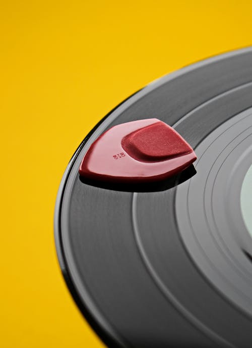 Close-up of a Guitar Pick Lying on a Vinyl Record