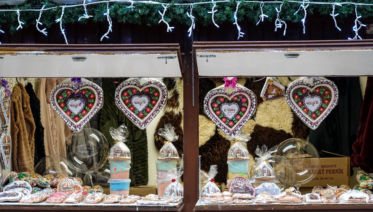 Colorful gingerbread hearts and sweets showcased in a festive market stall.
