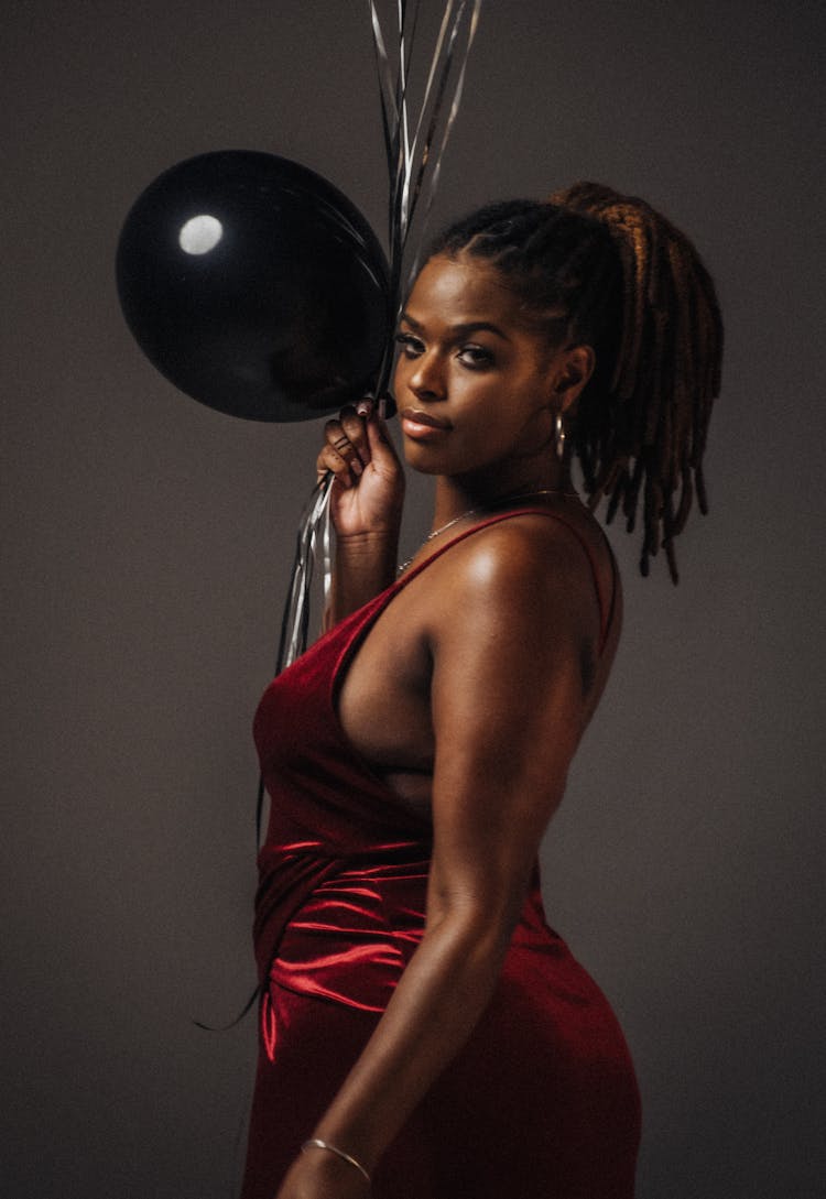 Portrait Of Woman In Red Dress And With Balloon