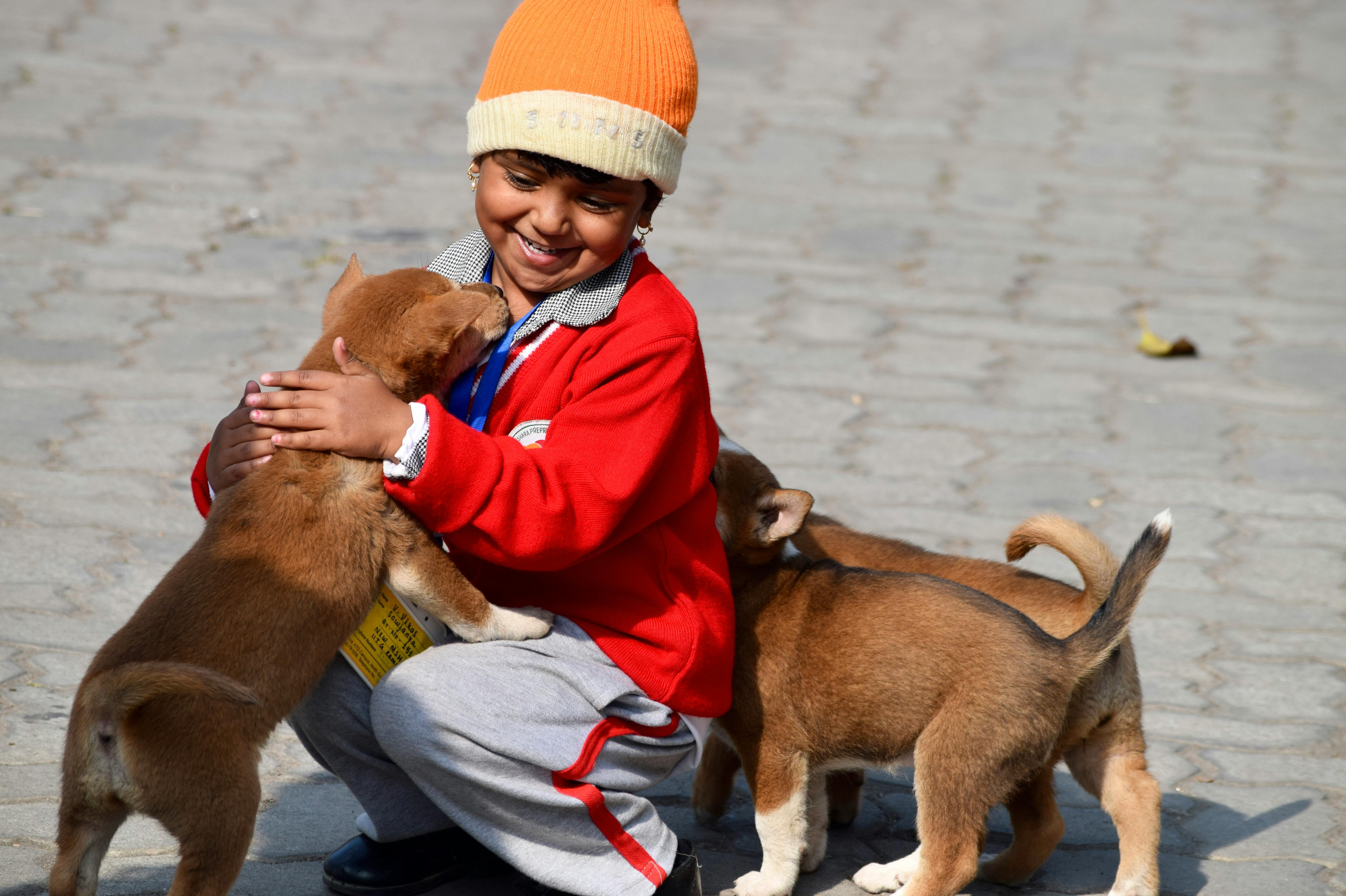 Smiling Girl Playing with Puppies