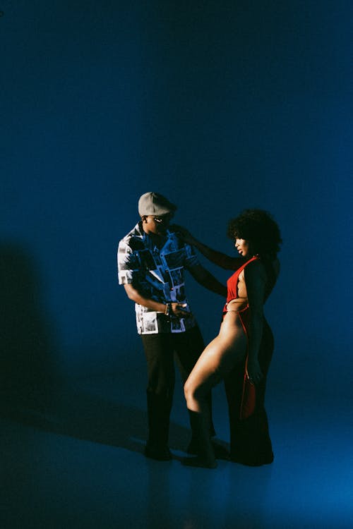 Woman in Red Dress and Man in Shirt