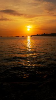 Capture of the serene golden sunset over a calm ocean, perfect for relaxation themes.