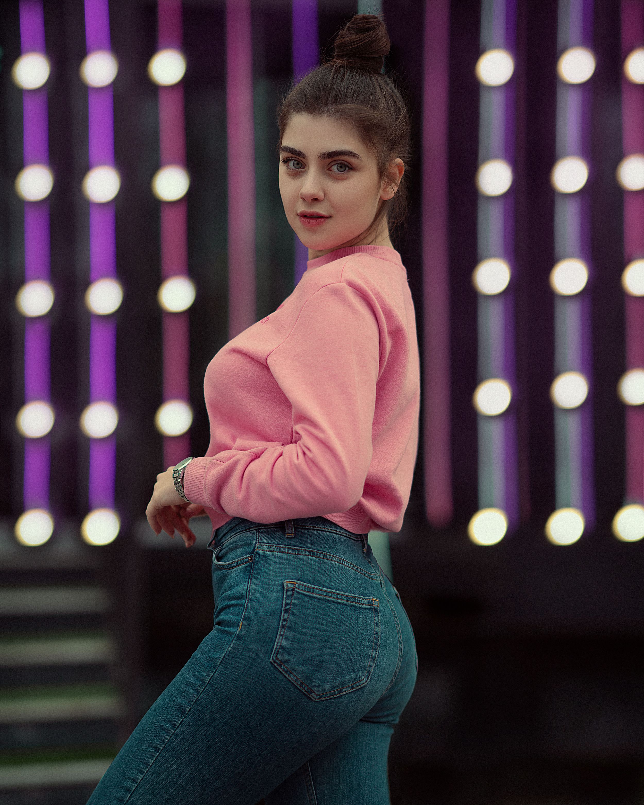 Woman in a pink knit sweater with jeans