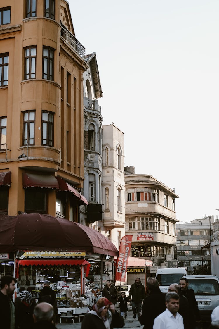 People Walking On The Street Near City Buildings