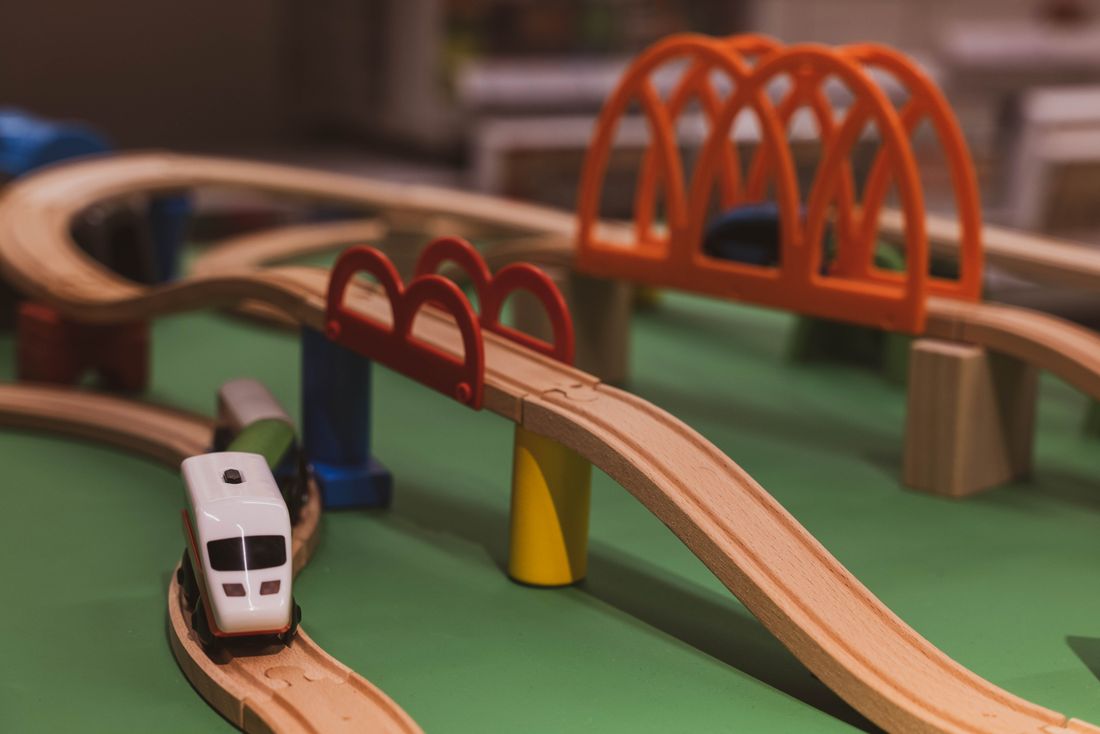 Wooden toy train track with a bridge