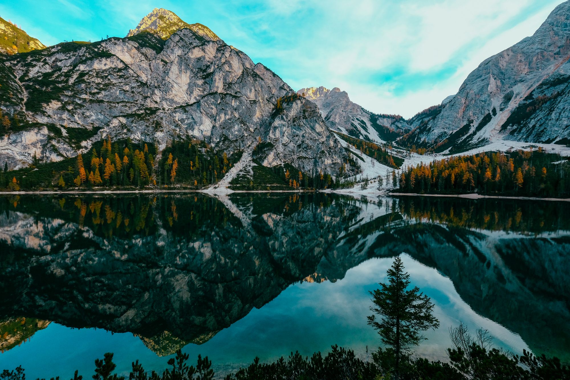 Mountains reflected in the still water of Lago di Braies