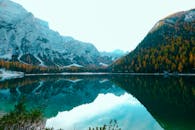 晶莹剔透的湖水中倒映着雄伟的山脉，四周环绕着秋天的色调