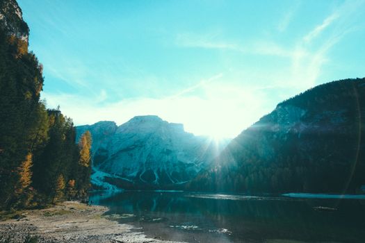 Stunning view of a mountain lake at sunrise with clear sky and reflections.