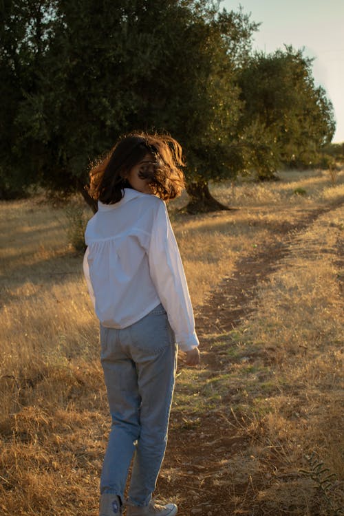 Girl Walking on Pathway