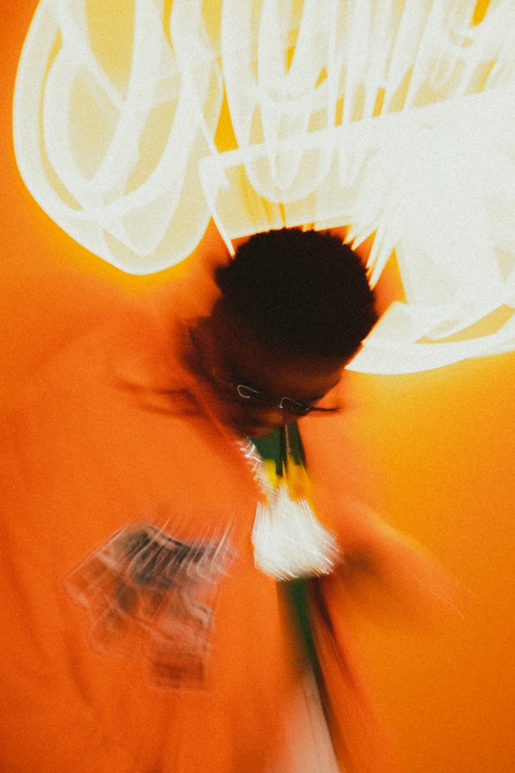 Man In Orange Jacket Wearing Black Sunglasses 