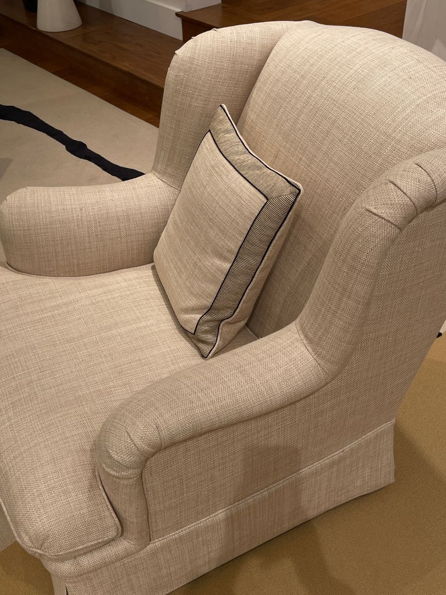 Beige armchair with a throw pillow