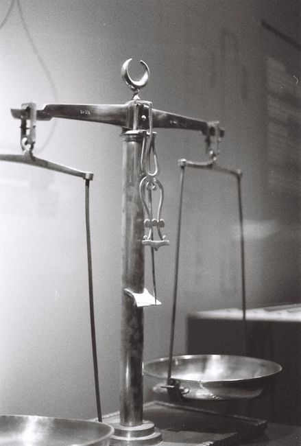 Black and white image of a vintage balance scale in an İstanbul museum display.