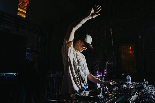 Free A DJ passionately playing music at a lively nightclub event, creating an electrifying atmosphere. Stock Photo
