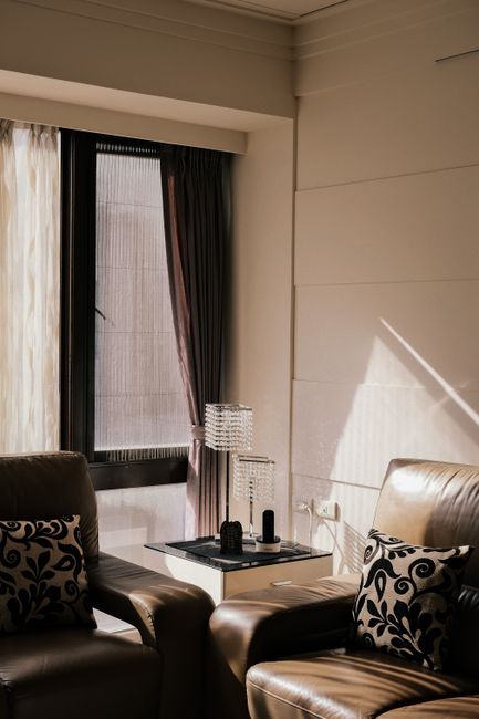 Warm cozy apartment interior featuring leather sofas and modern decor.