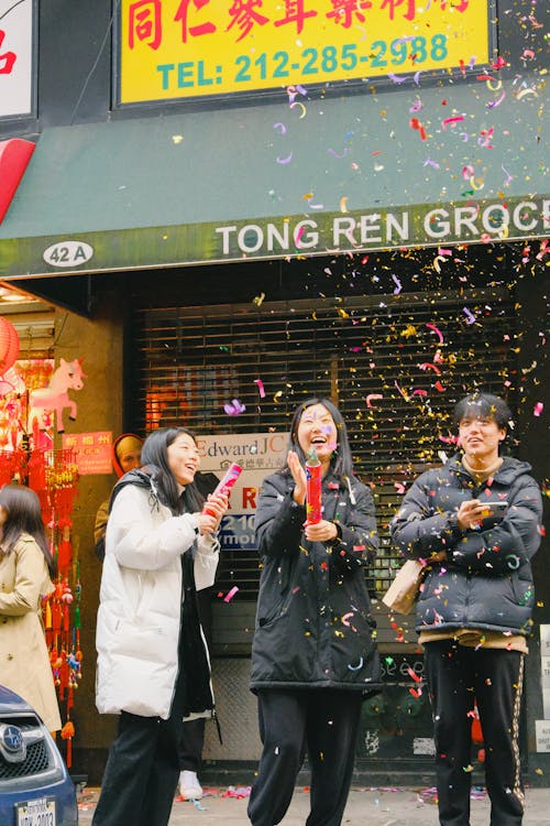 People Celebrating Chinese New Year with Confetti on Street