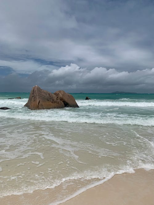 grátis Foto profissional grátis de areia, beira-mar, céu Foto profissional