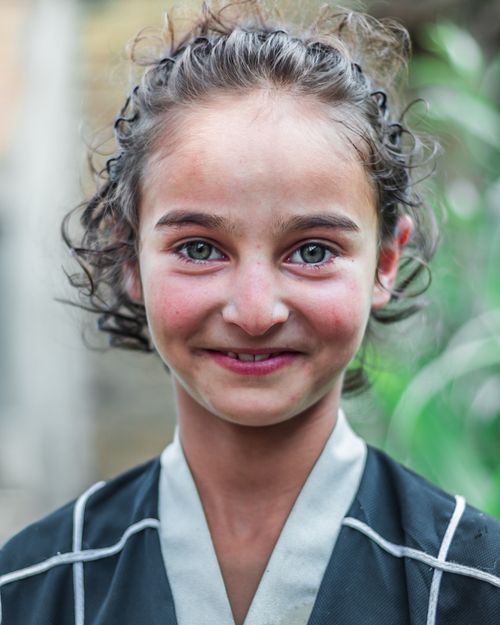 Free Adorable child smiling in an outdoor setting, showcasing innocence and joy. Stock Photo