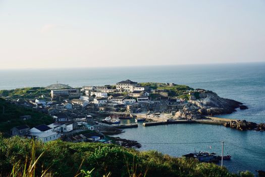 Scenic coastal village with a harbor overlooking the expansive ocean.