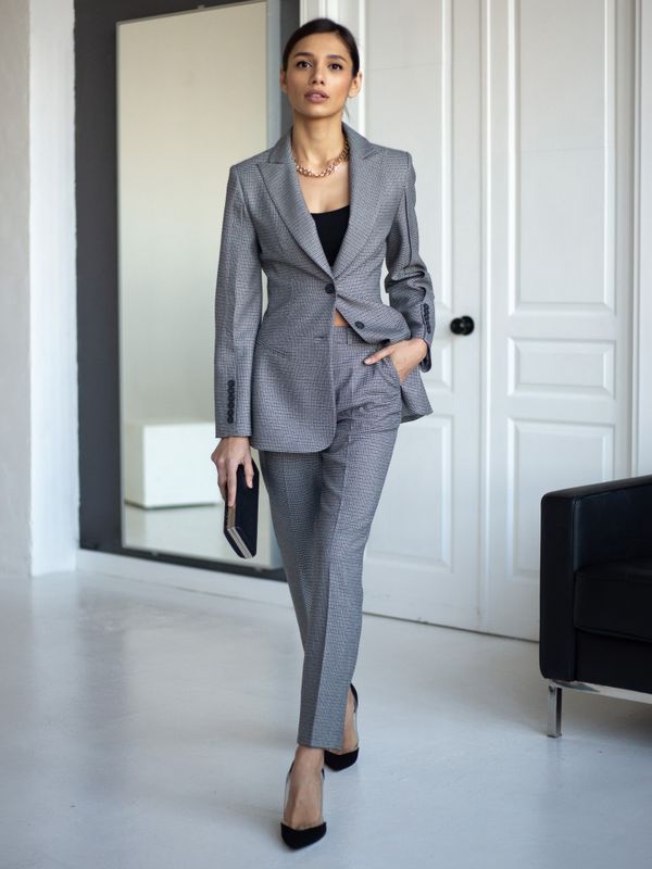 Professional woman wearing a tailored gray suit