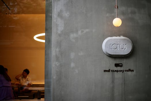 Stylish café featuring a minimalist design with concrete walls and decor.