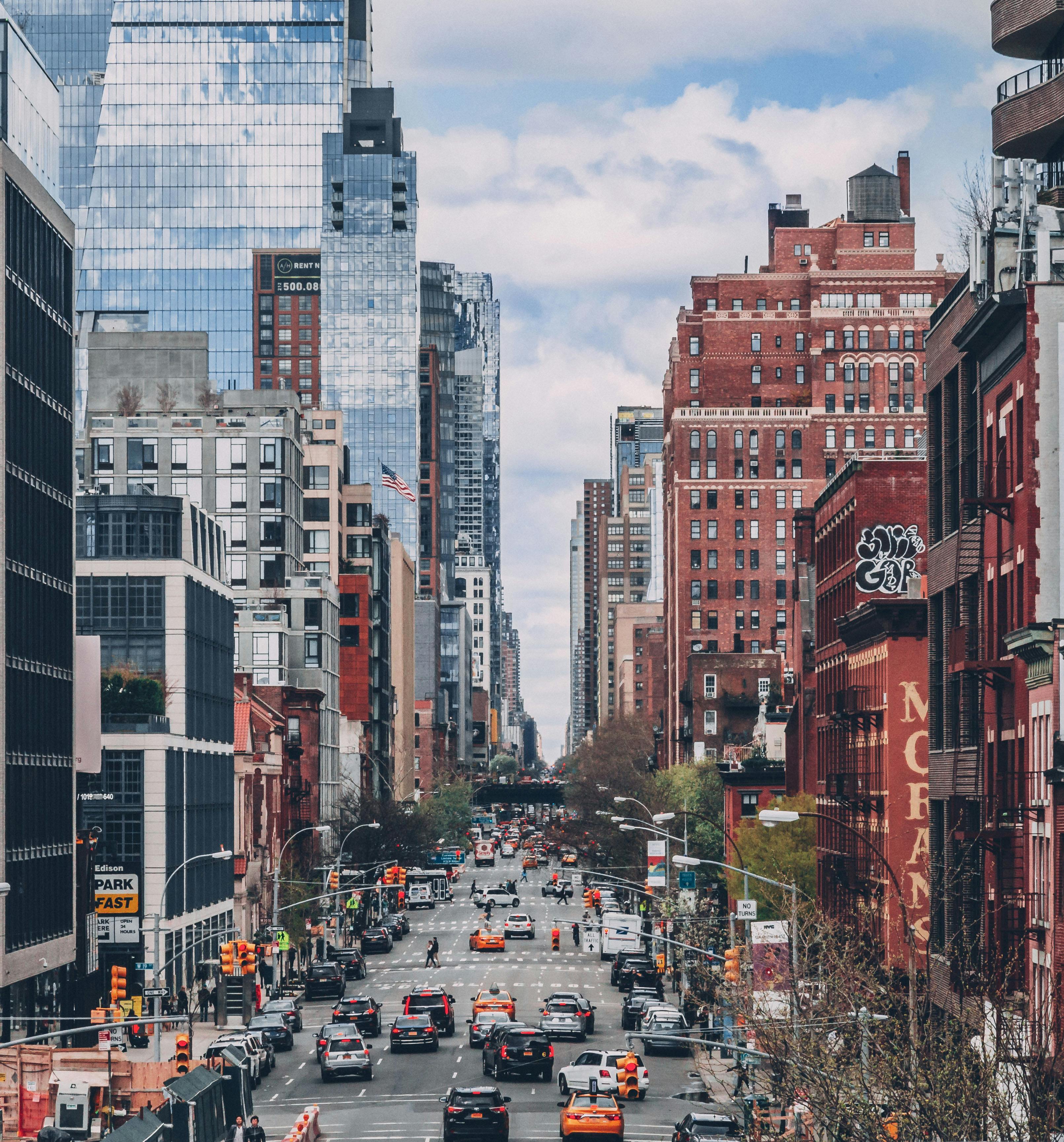 vehicles on road between high rise buildings