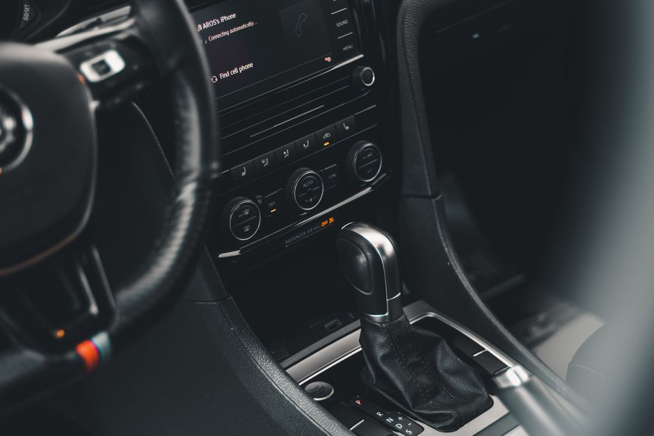 Close-up of Volkswagen car interior focusing on gear shift and dashboard.