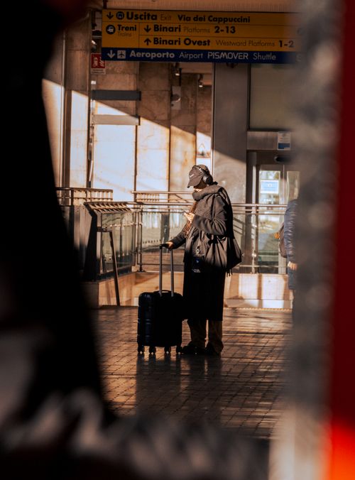 Free Man with suitcase at Pisa station, Tuscany, Italy, in urban setting. Stock Photo