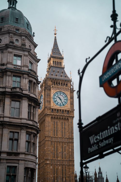 Free View of Big Ben tower next to the Westminster Subway sign in London, England. Stock Photo