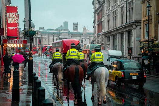 Rainy day in London with mounted police patrolling the vibrant city streets.