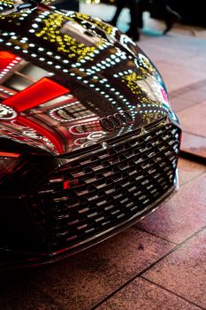 Close-up of a black Audi R8 with vivid reflections in London, capturing urban elegance and modern automotive design.