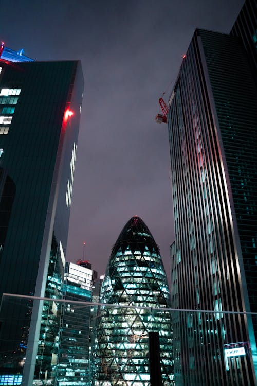 Low Angle Shot of Illuminated Skyscrapers in Downtown London at Night, England, UK 