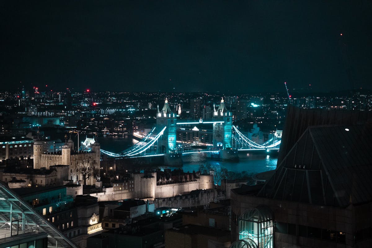 Aerial view of illuminated Tower Bridge at night in London with cityscape