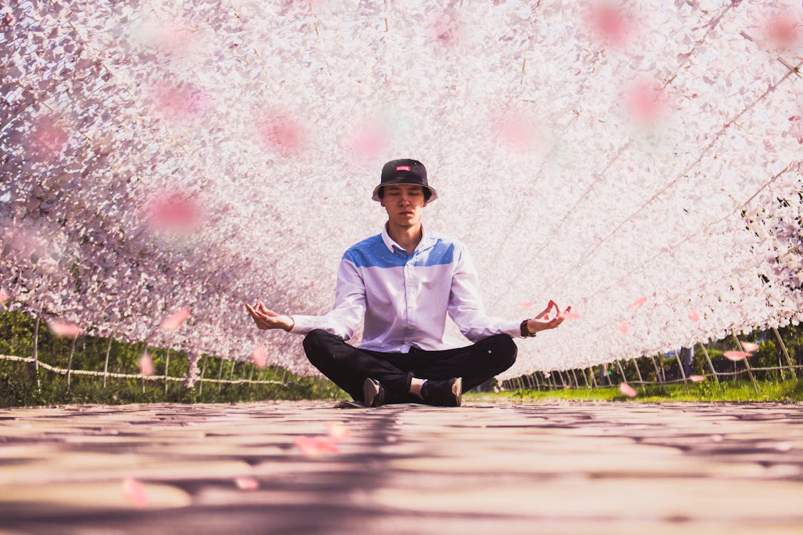 Free Man Meditating in the Middle of Pathway Stock Photo