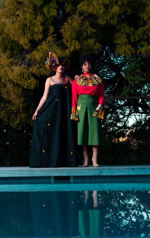 Free Two Woman Standing in Front of Body of Water Stock Photo