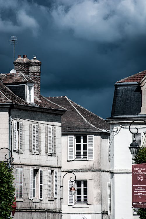 Photo of Old Houses Against a Stormy Sky