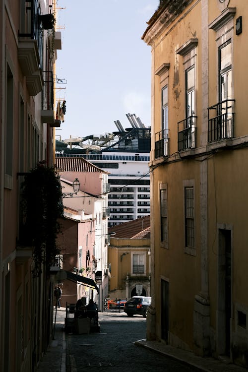 A Narrow Street Downhill in City 