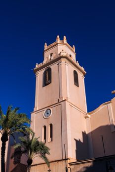 Low angle view of church tower in Crevillent, Spain under a clear blue sky.