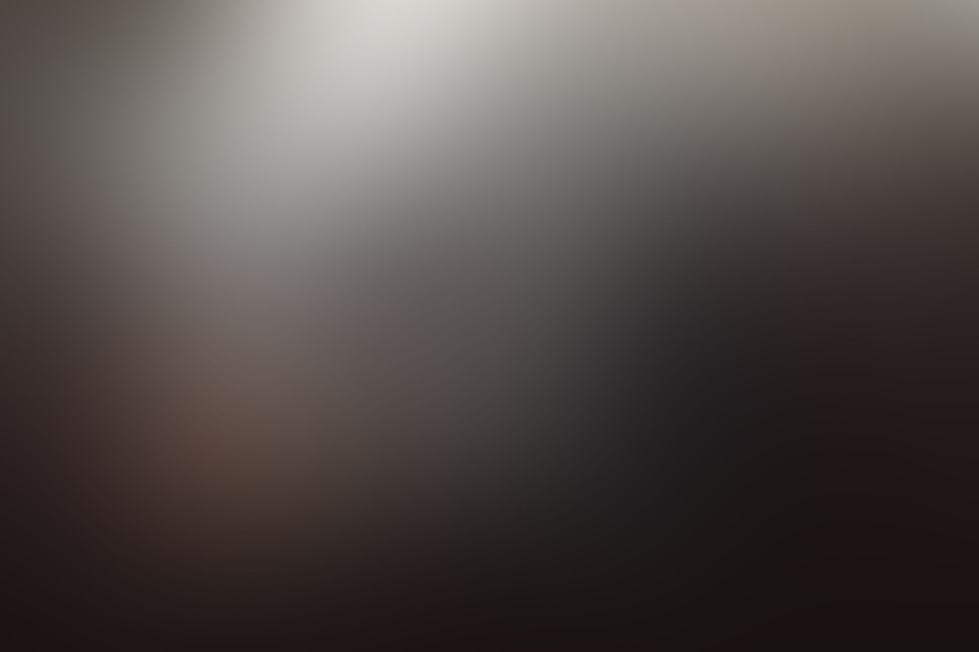 A dark and moody abstract image with soft gradient blur