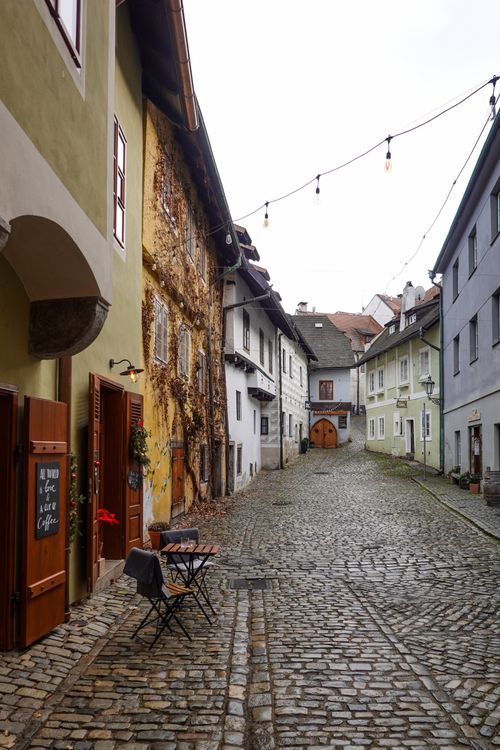 Free Explore an empty cobblestone street in Český Krumlov, showcasing historic buildings and quaint charm. Stock Photo
