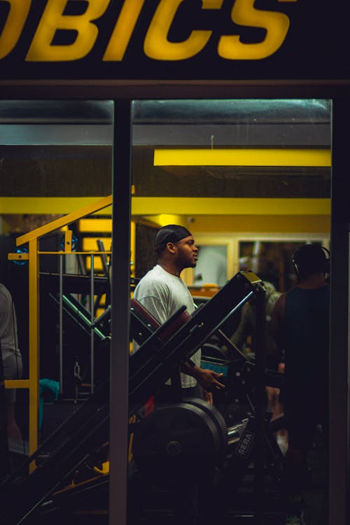 Candid Shot of Men Exercising at the Gym 