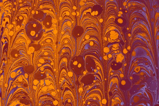 Colorful and intricate ebru marbling artwork featuring dynamic swirling patterns with vivid orange and purple hues.