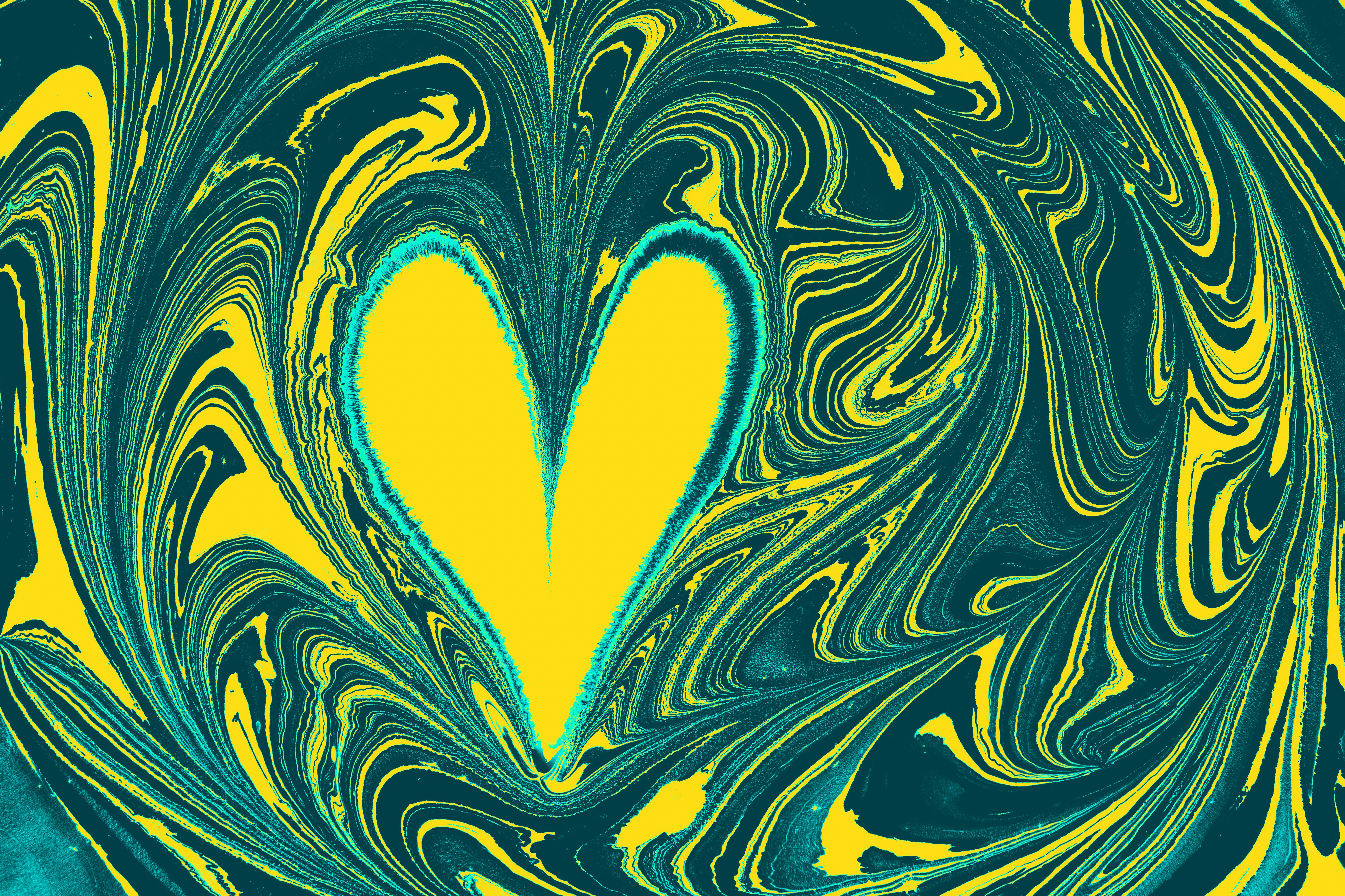 a yellow and green heart shaped painting on a blue background