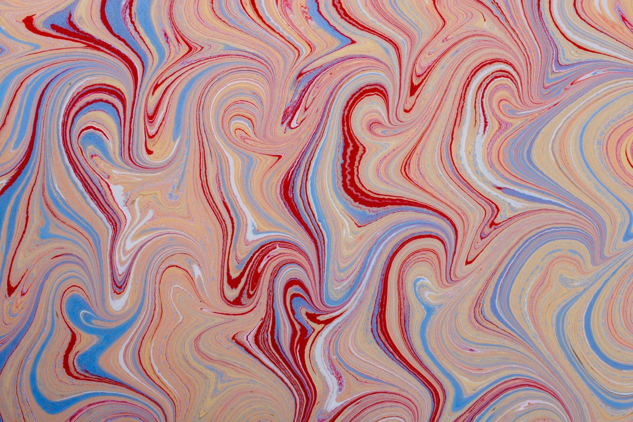 vibrant abstract pattern with swirling marble effect in red blue and b