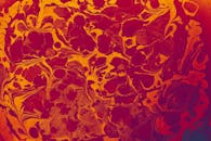 A red and orange abstract painting with a swirl
