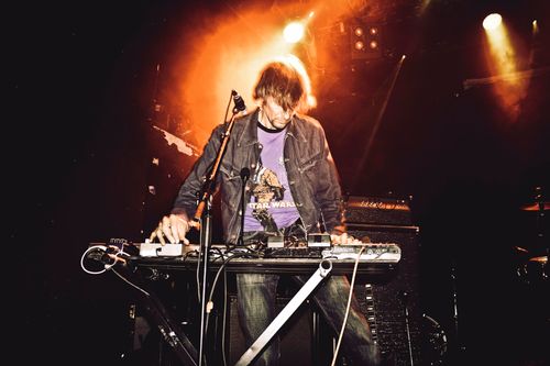 Free Energetic performance of a synth player on stage during a live music concert. Stock Photo